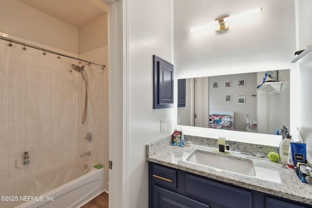 bathroom featuring vanity and tiled shower / bath combo