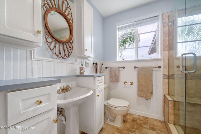 bathroom featuring walk in shower and toilet