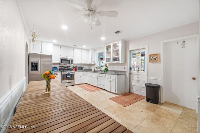 kitchen featuring light tile patterned floors, stainless steel appliances, sink, and white cabinets