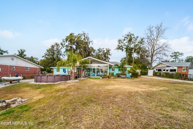 ranch-style home with covered porch and a front yard