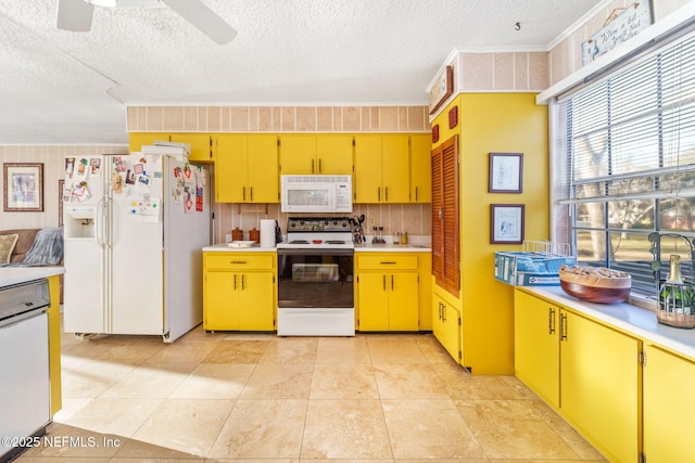 kitchen with white appliances, ceiling fan, backsplash, ornamental molding, and a textured ceiling