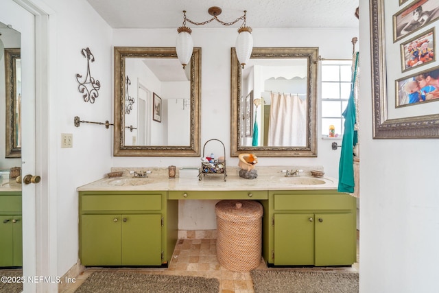 bathroom with vanity and a textured ceiling