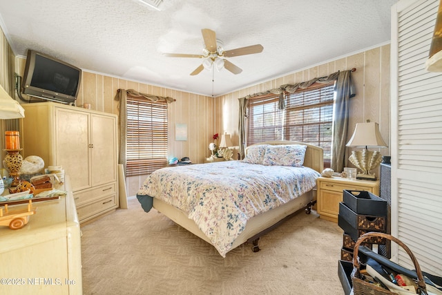 carpeted bedroom with a textured ceiling and ceiling fan