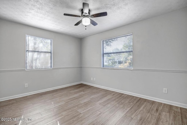 unfurnished room with ceiling fan, a textured ceiling, and light hardwood / wood-style floors