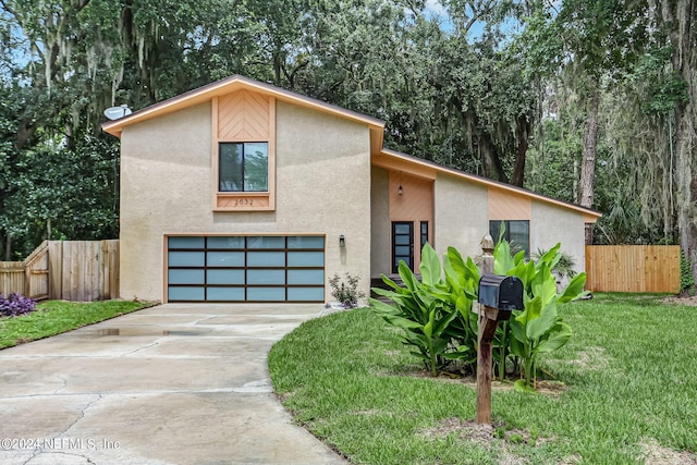 view of front of home with a garage and a front yard