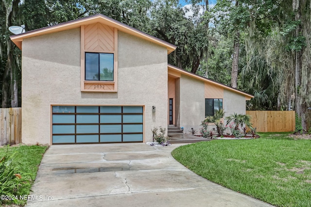 modern home featuring a garage and a front lawn