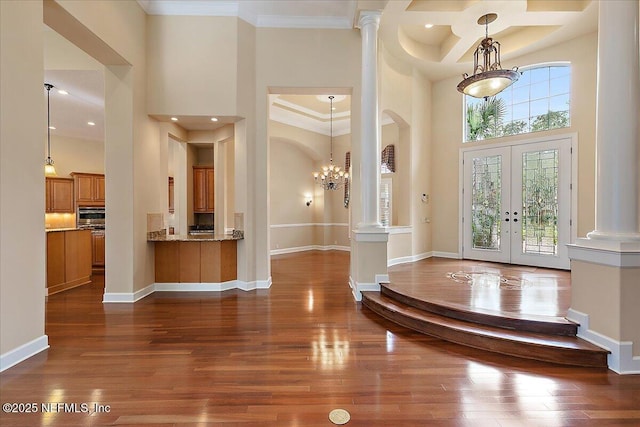 entryway with a towering ceiling and dark wood-style flooring