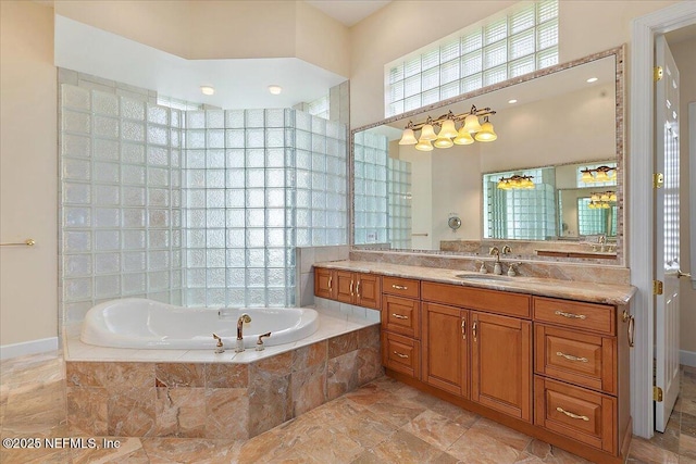 full bathroom featuring vanity and a garden tub