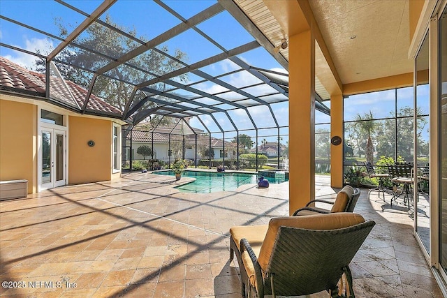 pool with a lanai and a patio area