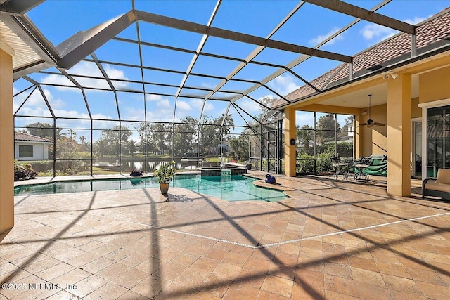 view of swimming pool with a ceiling fan, a lanai, a patio area, and a pool with connected hot tub