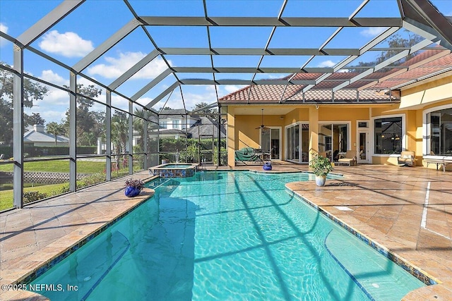 view of swimming pool with a lanai, a pool with connected hot tub, and a patio