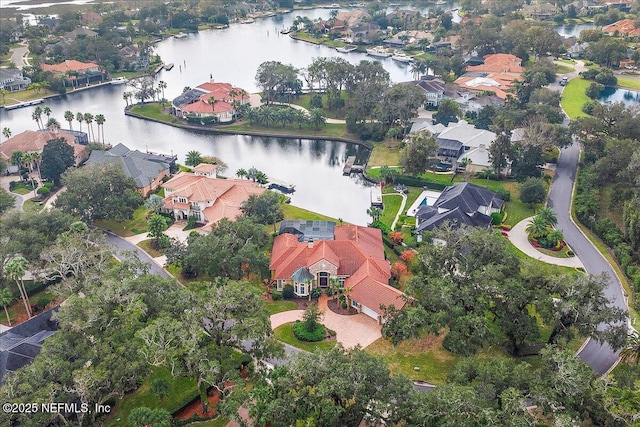 drone / aerial view featuring a residential view and a water view