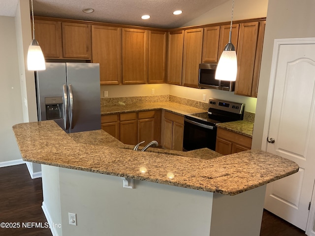 kitchen with lofted ceiling, dark wood-type flooring, a breakfast bar area, hanging light fixtures, and stainless steel appliances