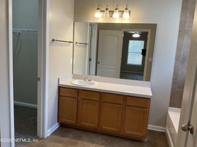 bathroom with vanity and a tub