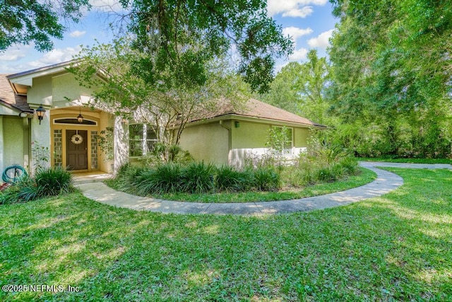 view of side of property with a lawn