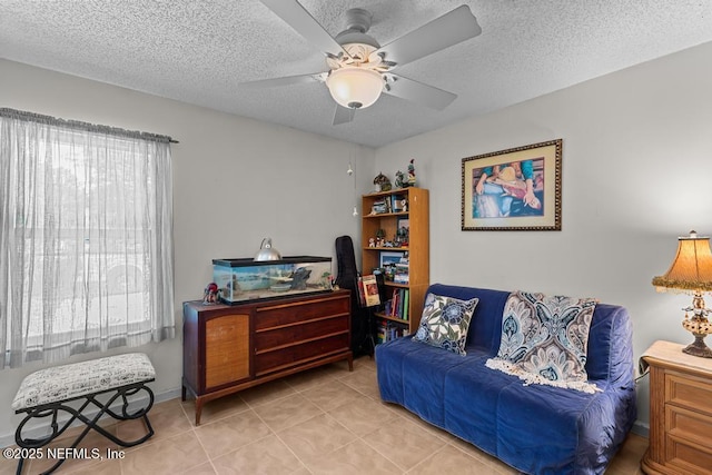 living area featuring light tile patterned flooring, a healthy amount of sunlight, and a textured ceiling