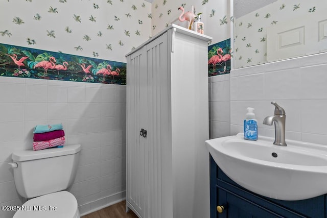 bathroom featuring vanity, wood-type flooring, and toilet