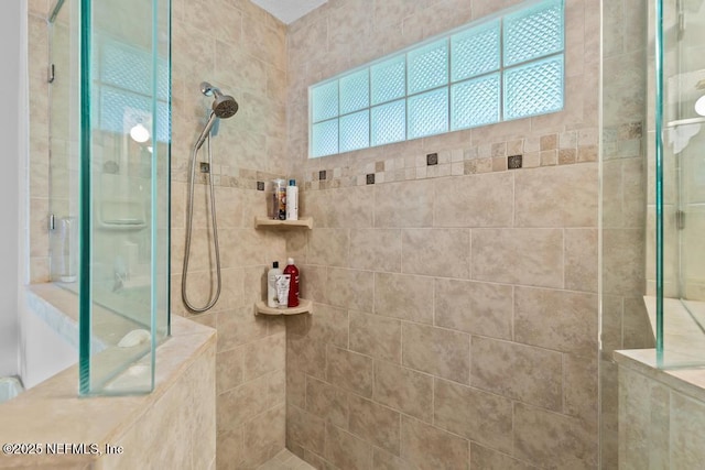 bathroom with a tile shower