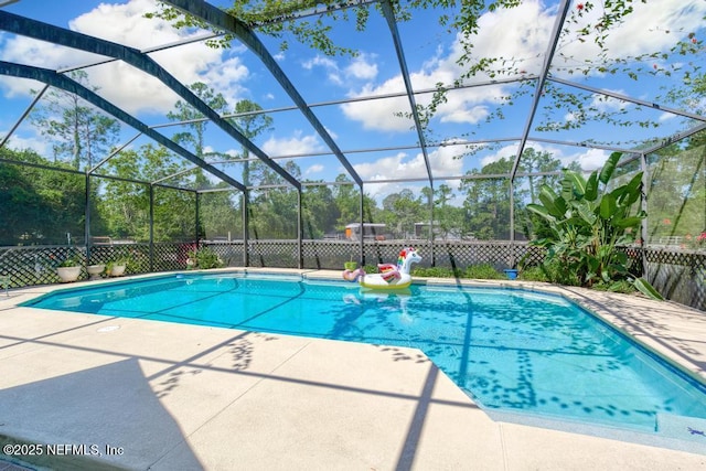 view of pool with a lanai and a patio area