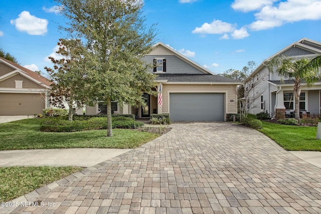 view of front of house featuring a garage and a front lawn