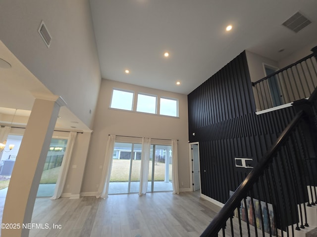 interior space featuring hardwood / wood-style floors and a high ceiling