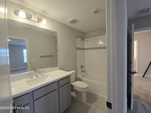 bathroom featuring visible vents, toilet, vanity, and a textured ceiling