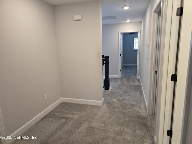 hall featuring light colored carpet