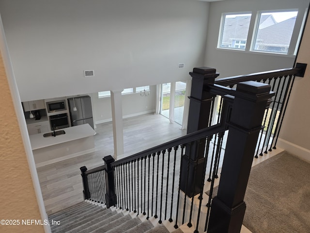 stairs featuring hardwood / wood-style flooring