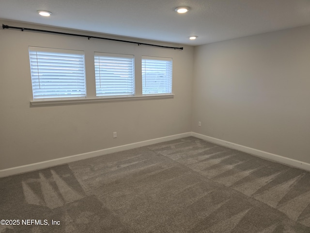 carpeted spare room featuring recessed lighting and baseboards