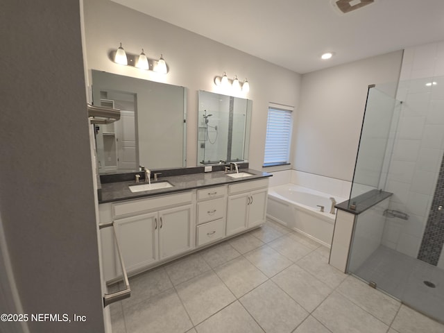 bathroom featuring tile patterned flooring, vanity, and separate shower and tub