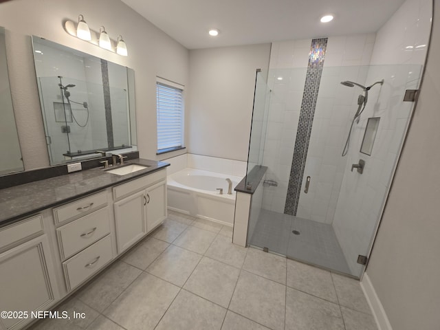 bathroom featuring vanity, plus walk in shower, and tile patterned flooring