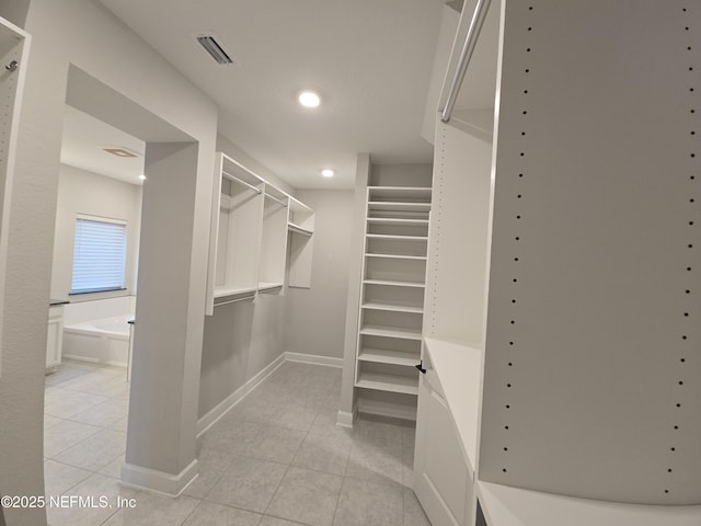 walk in closet with light tile patterned floors and visible vents