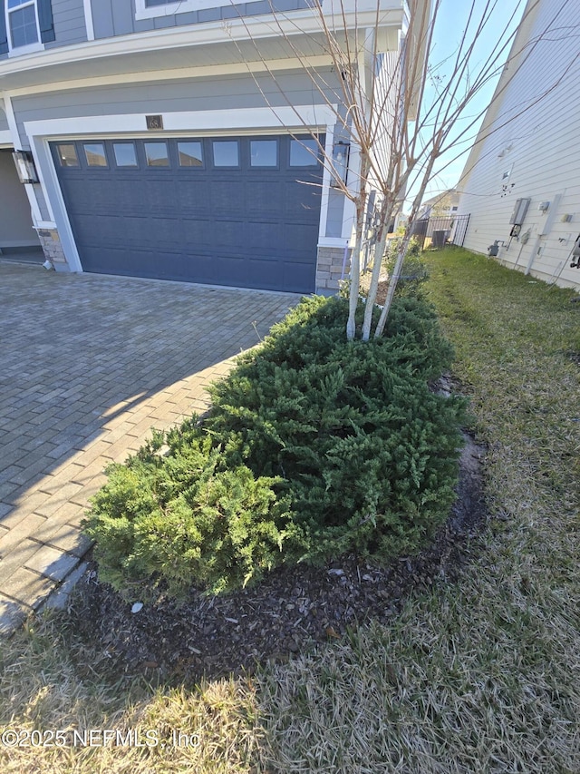 garage with decorative driveway