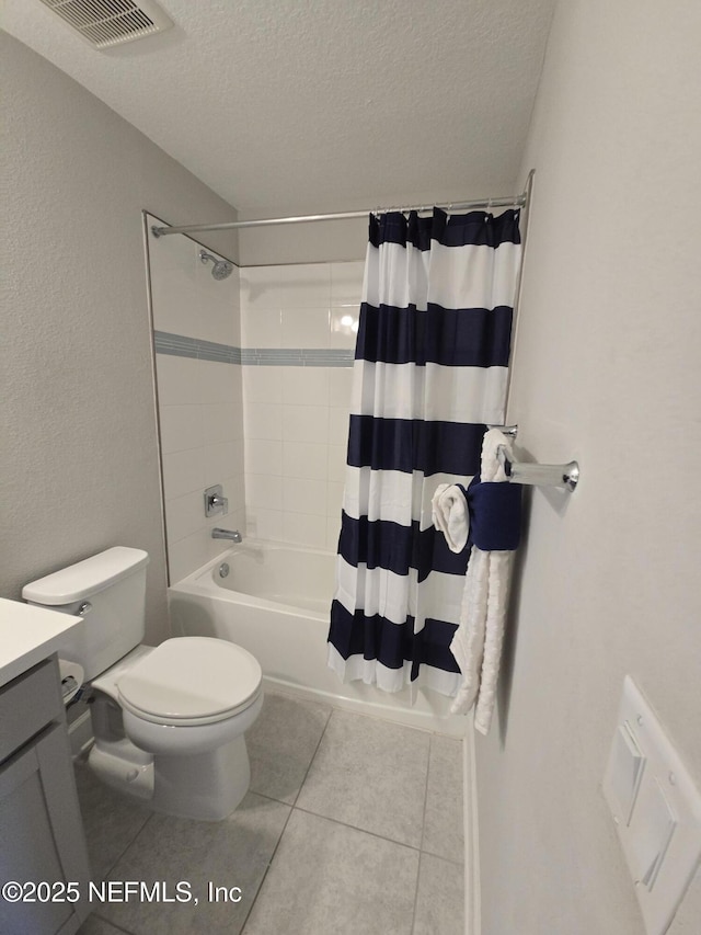 full bathroom with vanity, toilet, shower / bathtub combination with curtain, tile patterned floors, and a textured ceiling