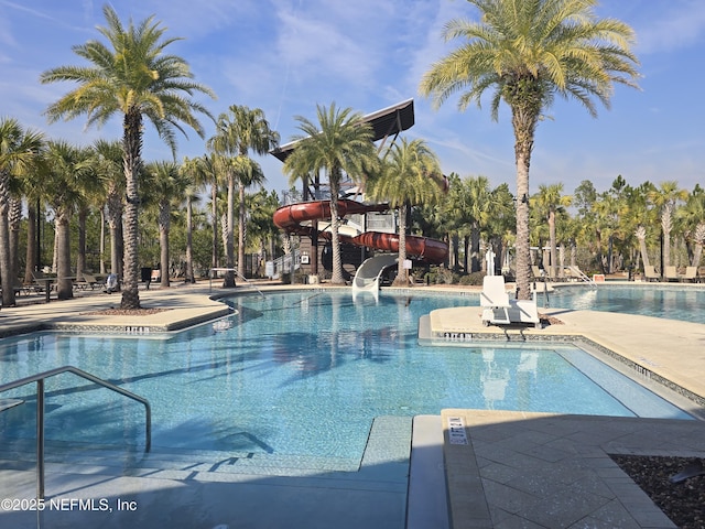 view of swimming pool with a water slide