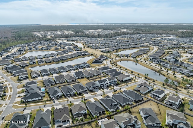 drone / aerial view with a residential view and a water view