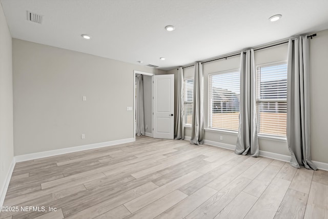 unfurnished room featuring recessed lighting, visible vents, baseboards, and light wood-style flooring