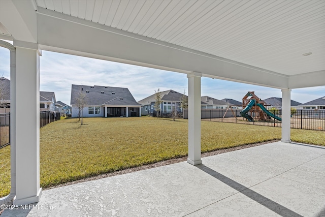 view of patio / terrace featuring a residential view, fence, and a playground