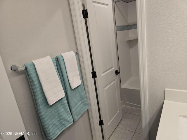 bathroom featuring tile patterned floors and washtub / shower combination