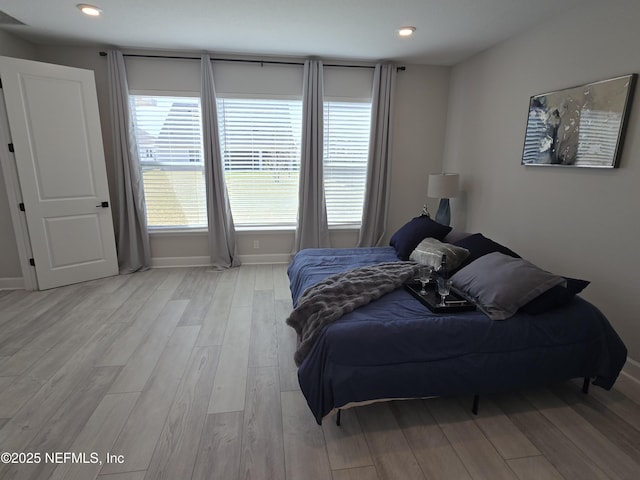 bedroom with recessed lighting, baseboards, and light wood-style floors