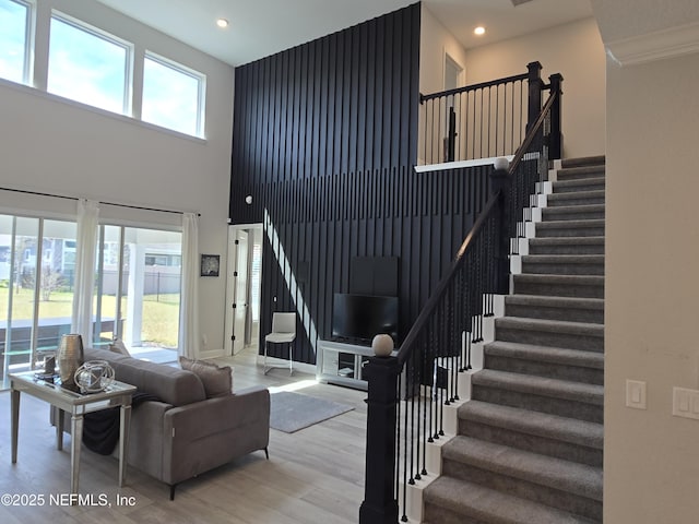 living room featuring recessed lighting, stairway, a healthy amount of sunlight, and wood finished floors