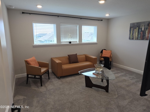 carpeted living area featuring recessed lighting, baseboards, and plenty of natural light