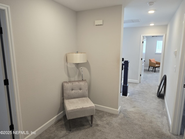 sitting room featuring baseboards and carpet