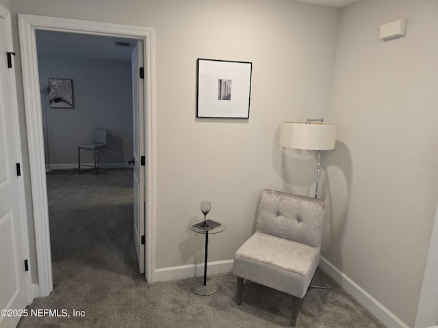 sitting room with baseboards and carpet flooring