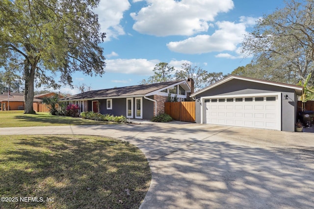 ranch-style home featuring a garage and a front lawn