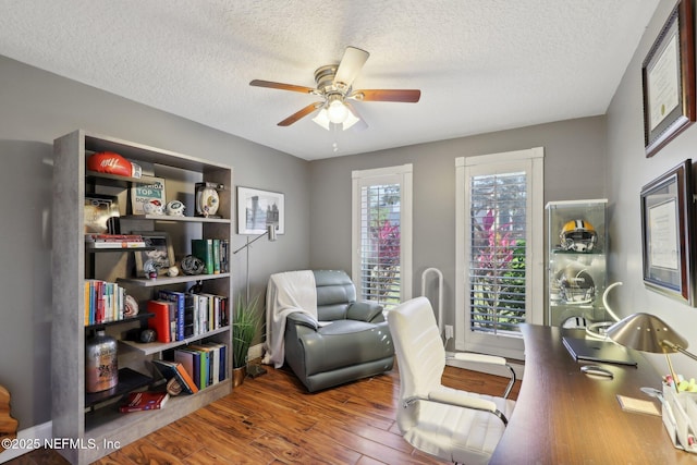 office featuring a textured ceiling, wood-type flooring, and ceiling fan