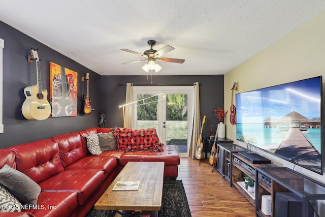 living room with ceiling fan and a textured ceiling