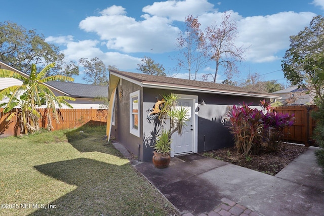 view of outbuilding featuring a yard