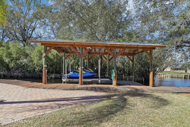 surrounding community featuring a water view and a boat dock