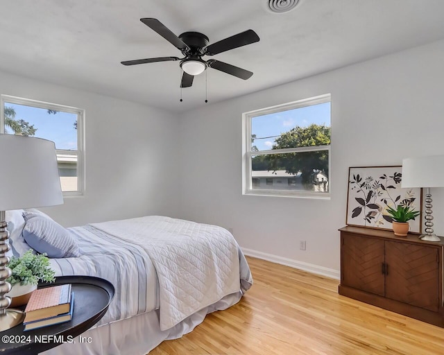 bedroom with light hardwood / wood-style floors and ceiling fan